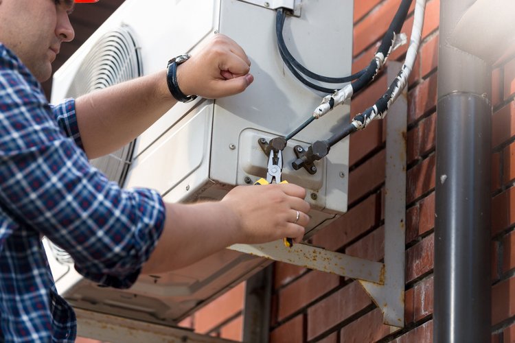 Nova Air technician diagnosing an air conditioning system